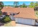 Aerial shot of the home showing the distinctive tile roof and attached garage, surrounded by mature landscaping and natural beauty at 347 Oak Lane Dr, Ocala, FL 34472