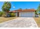 A single-story house with a tile roof and a driveway at 347 Oak Lane Dr, Ocala, FL 34472