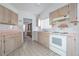 Kitchen featuring tiled countertops, white appliances, and plenty of storage at 347 Oak Lane Dr, Ocala, FL 34472