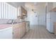Functional kitchen with pink countertops, white appliances, and tile flooring at 347 Oak Lane Dr, Ocala, FL 34472