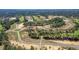 An aerial view of the neighborhood showing the roads, home sites, and golf course at 357 Hickory Course Trl, Ocala, FL 34472