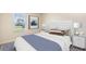 Comfortable bedroom with a serene decor, featuring a bed with pillows and a bedside table with a lamp at 357 Hickory Course Trl, Ocala, FL 34472