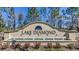 Entrance sign for Lake Diamond community with a fountain, landscaping, and blue sky in the background at 357 Hickory Course Trl, Ocala, FL 34472