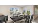 Bright dining room with a large table, seating for six and a view of the outdoor living space at 357 Hickory Course Trl, Ocala, FL 34472