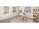 Bright home office with a glass desk, comfortable chair and a bookcase with decor at 357 Hickory Course Trl, Ocala, FL 34472