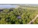 Secluded home hidden among lush trees with a screened pool enclosure, aerial view at 3579 Sw Shorewood Dr, Dunnellon, FL 34431