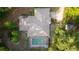 Aerial view of the home with a screened-in pool and mature trees at 3579 Sw Shorewood Dr, Dunnellon, FL 34431