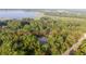 Aerial view of the property's location with a pool and dense trees at 3579 Sw Shorewood Dr, Dunnellon, FL 34431