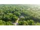 Aerial view of a home surrounded by a dense forest at 3579 Sw Shorewood Dr, Dunnellon, FL 34431