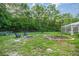 Spacious backyard offering ample room for outdoor activities, featuring a firepit at 3579 Sw Shorewood Dr, Dunnellon, FL 34431