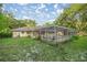 Large, private backyard featuring a screened-in pool area and lush landscaping at 3579 Sw Shorewood Dr, Dunnellon, FL 34431