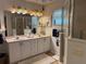 Well-lit bathroom with a large mirror, vanity, and walk-in shower, designed for both functionality and comfort at 3579 Sw Shorewood Dr, Dunnellon, FL 34431