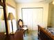 Bright bedroom featuring a chair and side table, neutral walls, and a built-in closet at 3579 Sw Shorewood Dr, Dunnellon, FL 34431
