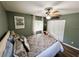 Comfortable bedroom features green walls, wood floors, closet space and a window with natural light at 3579 Sw Shorewood Dr, Dunnellon, FL 34431