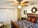 Bright bedroom features a ceiling fan, closet, and wooden bed frame for a modern design at 3579 Sw Shorewood Dr, Dunnellon, FL 34431