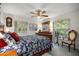 Inviting bedroom featuring large windows, soft lighting, and a serene atmosphere at 3579 Sw Shorewood Dr, Dunnellon, FL 34431