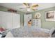 Cozy bedroom with a ceiling fan, floral decorations and a view to the rest of the home at 3579 Sw Shorewood Dr, Dunnellon, FL 34431
