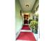 Inviting entryway with a red mat and tasteful decorations, leading to a glimpse of the elegant interior at 3579 Sw Shorewood Dr, Dunnellon, FL 34431