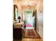 Charming foyer with decorative mirror, wooden dresser, and tiled flooring at 3579 Sw Shorewood Dr, Dunnellon, FL 34431