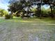 Large front lawn and mature trees at 3579 Sw Shorewood Dr, Dunnellon, FL 34431
