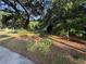 Grassy front lawn shaded by mature trees creates a peaceful entrance and adds to the property's charm at 3579 Sw Shorewood Dr, Dunnellon, FL 34431
