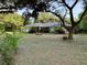 Charming house with lush landscaping and a spacious front yard surrounded by mature trees at 3579 Sw Shorewood Dr, Dunnellon, FL 34431