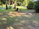 A cozy seating area creates a relaxing spot to enjoy the peaceful front yard at 3579 Sw Shorewood Dr, Dunnellon, FL 34431