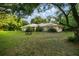 Spacious front yard featuring lush grass and mature trees at 3579 Sw Shorewood Dr, Dunnellon, FL 34431