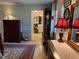 Hallway view leading to a bathroom, featuring a decorative lamp, area rug, and a glimpse of the bathroom's vanity at 3579 Sw Shorewood Dr, Dunnellon, FL 34431