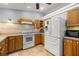 Kitchen with wooden cabinets, modern appliances, tile backsplash and tile flooring at 3579 Sw Shorewood Dr, Dunnellon, FL 34431