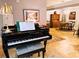 Elegant living room showcases a grand piano, complemented by a dining area and classic decor at 3579 Sw Shorewood Dr, Dunnellon, FL 34431