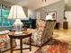 Cozy living room with floral patterned sofas, a grand piano, and a decorative area rug creating a warm ambiance at 3579 Sw Shorewood Dr, Dunnellon, FL 34431
