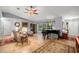 Living room featuring a large window, piano, ceiling fan and tile floor at 3579 Sw Shorewood Dr, Dunnellon, FL 34431