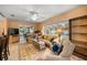Living room with natural light, comfortable seating, tile floors and view of pool at 3579 Sw Shorewood Dr, Dunnellon, FL 34431