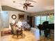 Inviting living room featuring tile flooring, a decorative ceiling fan, and a large window with a view of the yard at 3579 Sw Shorewood Dr, Dunnellon, FL 34431