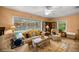 Inviting living room with views of the screened-in pool, comfortable seating and tile floor at 3579 Sw Shorewood Dr, Dunnellon, FL 34431