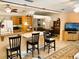 Open-concept living space featuring a kitchen with breakfast bar and a dining area with a chandelier at 3579 Sw Shorewood Dr, Dunnellon, FL 34431