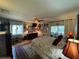 Comfortable main bedroom with an area rug, ceiling fan, and access to a sunroom, creating a relaxing retreat at 3579 Sw Shorewood Dr, Dunnellon, FL 34431