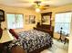 Cozy main bedroom with ceiling fan, artwork and furnishings featuring a blend of textures and patterns at 3579 Sw Shorewood Dr, Dunnellon, FL 34431
