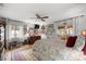 Bright bedroom featuring large windows, ceiling fan, neutral paint, and beautiful natural light at 3579 Sw Shorewood Dr, Dunnellon, FL 34431