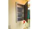 Open medicine cabinet in bathroom showing storage space for toiletries and personal care items at 3579 Sw Shorewood Dr, Dunnellon, FL 34431