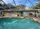 Private pool with a screened-in patio, offering a relaxing outdoor oasis for swimming and lounging at 3579 Sw Shorewood Dr, Dunnellon, FL 34431