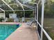 Sparkling in-ground pool with ample seating and a large screened enclosure; great backyard at 3579 Sw Shorewood Dr, Dunnellon, FL 34431