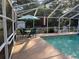 Pool patio with plenty of comfortable seating, umbrella and pool-side relaxing at 3579 Sw Shorewood Dr, Dunnellon, FL 34431