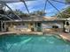 Enclosed pool featuring ample seating, green and blue balls, and a refreshing water space at 3579 Sw Shorewood Dr, Dunnellon, FL 34431