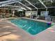 Inviting screened-in pool area with chairs, outdoor seating, and colorful floating balls at 3579 Sw Shorewood Dr, Dunnellon, FL 34431