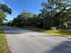 Street view showing the property, mature trees, and grassy front yard at 3579 Sw Shorewood Dr, Dunnellon, FL 34431
