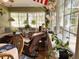 Bright sunroom featuring tile flooring, comfortable seating, and large windows offering ample natural light and views at 3579 Sw Shorewood Dr, Dunnellon, FL 34431