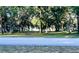 A picturesque scene showcasing a serene street view framed by lush trees and greenery at 3579 Sw Shorewood Dr, Dunnellon, FL 34431