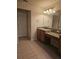 Well-lit bathroom with granite counters and vanity, and neutral tile flooring at 3918 Sw 57Th Ave, Ocala, FL 34474